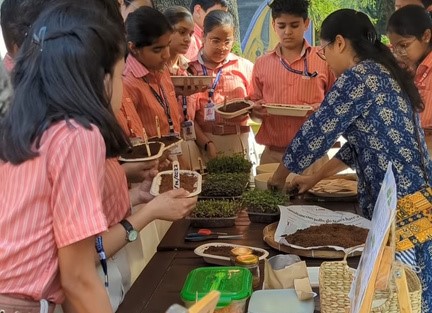 Nabanita giving a lecture to a group outdoors